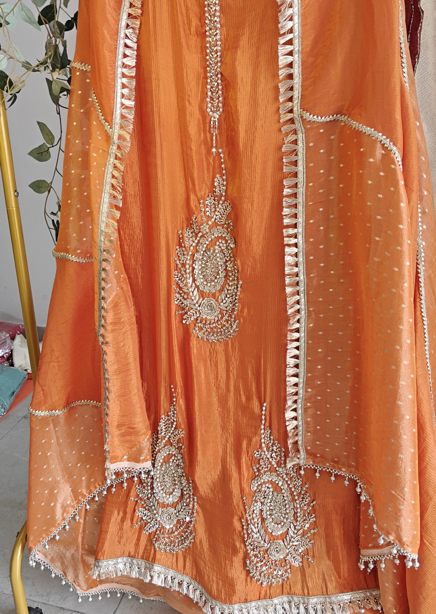 Orange Designer Partywear shimmer tissue unstitched suit.
