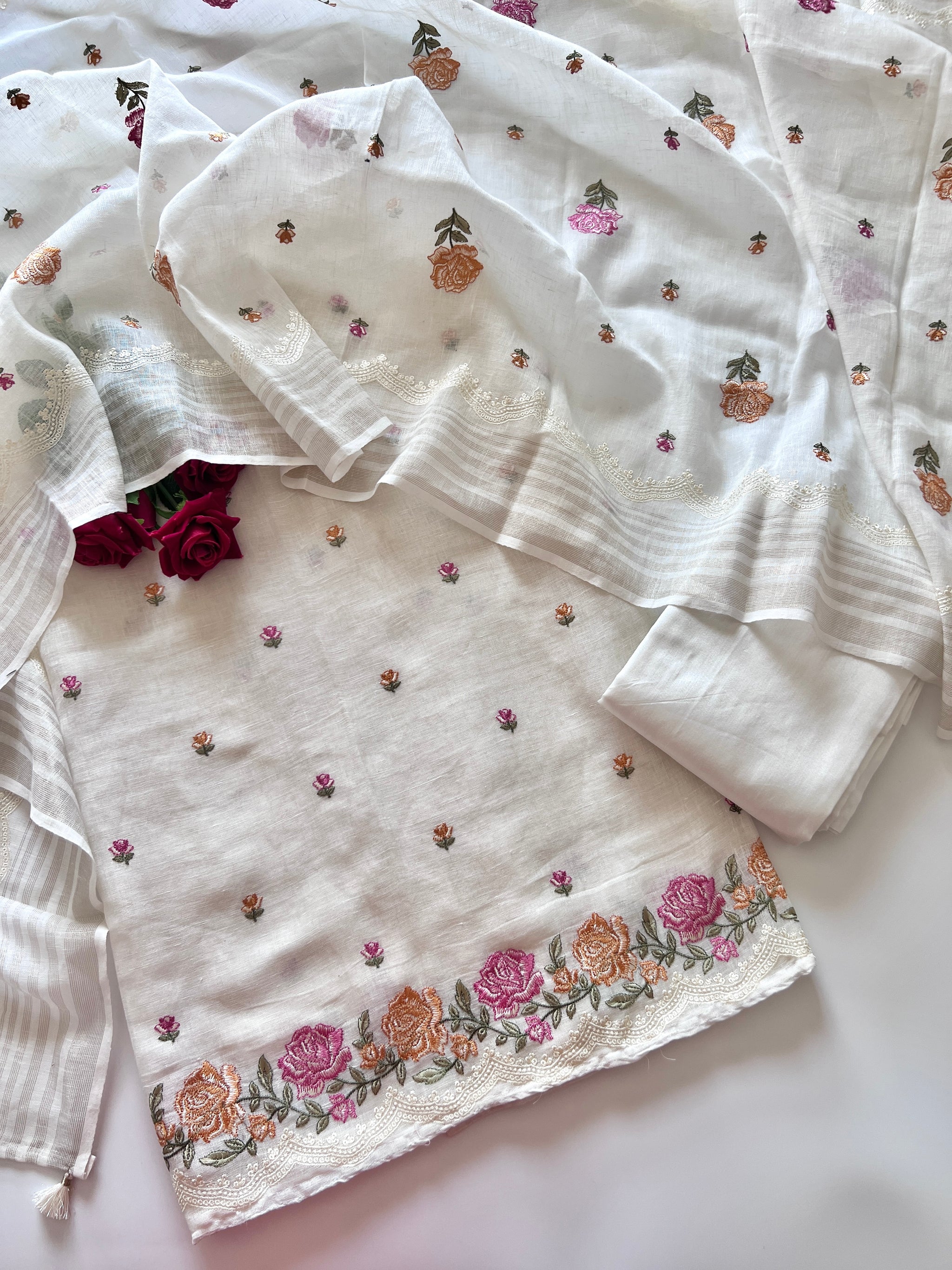 White linen unstitched suit with colorful floral embroidery for women
