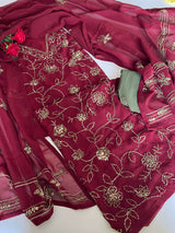 A deep maroon red ethnic suit set with intricate gold floral embroidery, featuring a kurta, matching dupatta, and olive green bottom fabric piece Unstitched suit