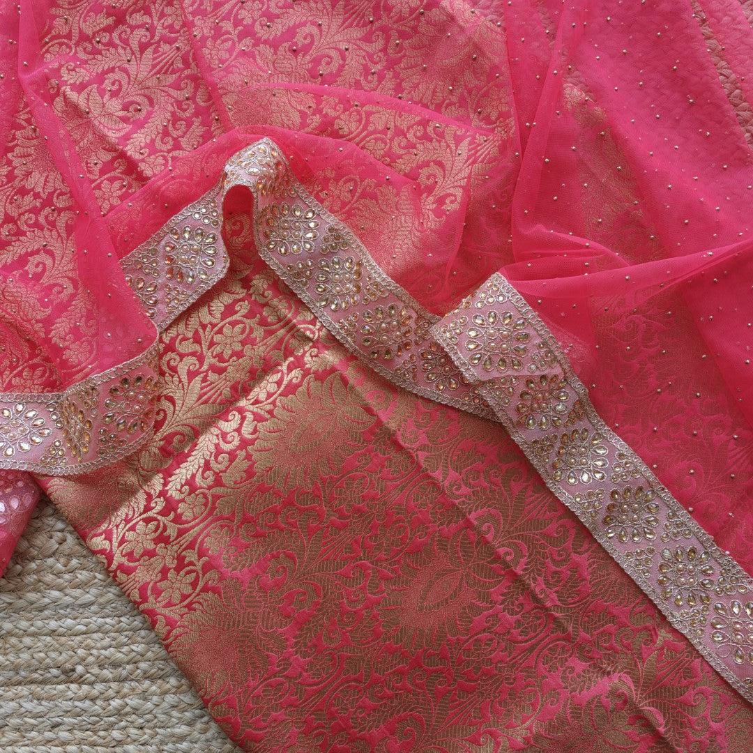 Elegant pink salwar suit material featuring kundan lace border and shimmering net dupatta