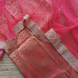 Elegant pink salwar suit material featuring kundan lace border and shimmering net dupatta