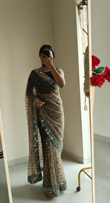 Dark Net saree with multi color thread embroidery and mirror border.