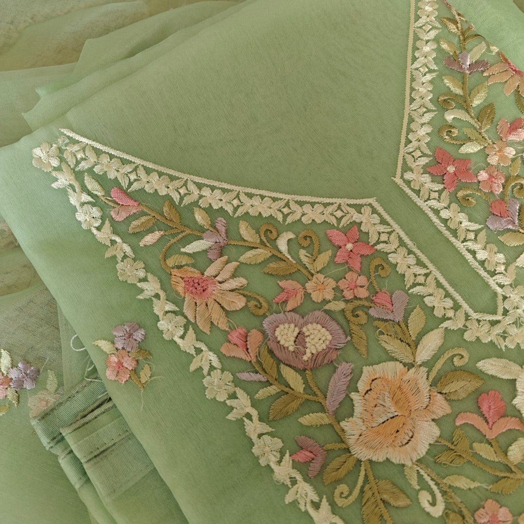 Pastel green unstitched salwar suit material with floral thread embroidery on neckline