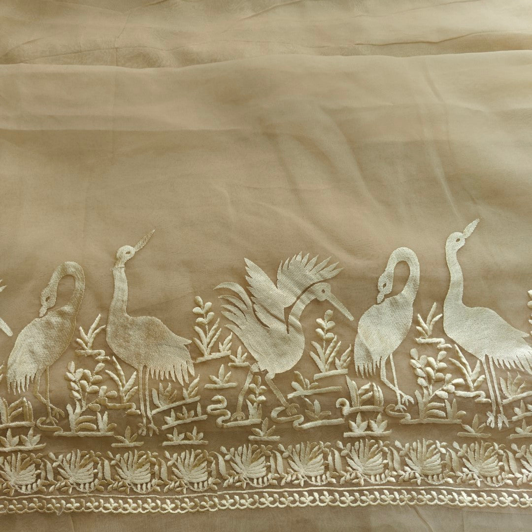 Decorative fabric with embroidered birds and plants on a beige background