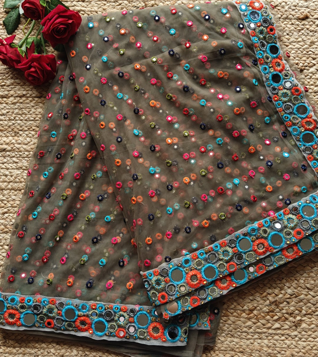 Dark Net saree with multi color thread embroidery and mirror border.