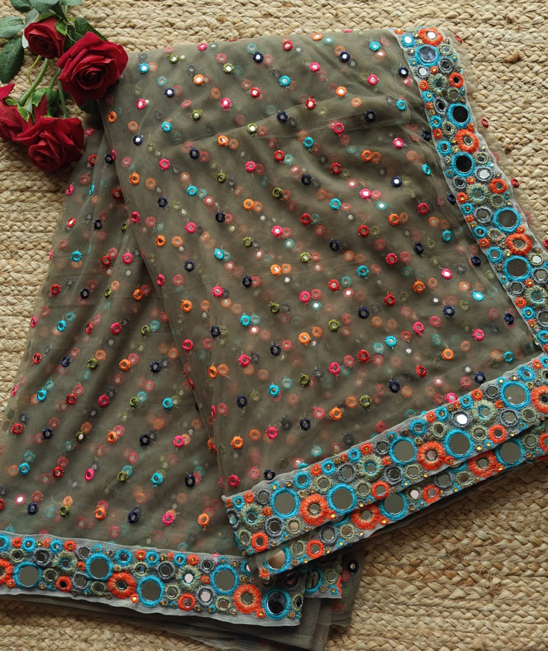 Dark Net saree with multi color thread embroidery and mirror border.