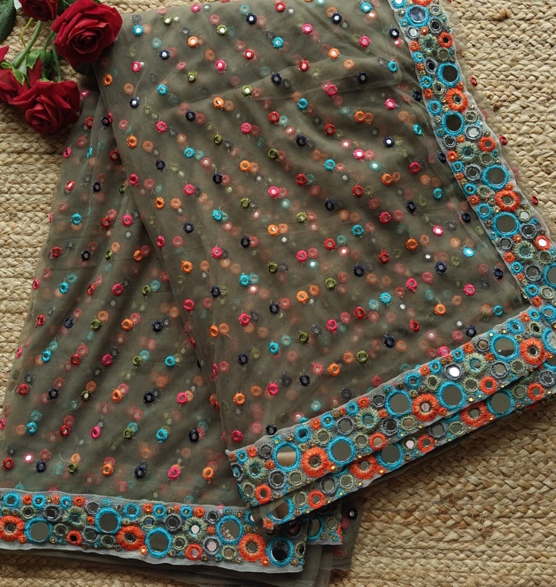 Dark Net saree with multi color thread embroidery and mirror border.