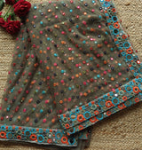 Dark Net saree with multi color thread embroidery and mirror border.