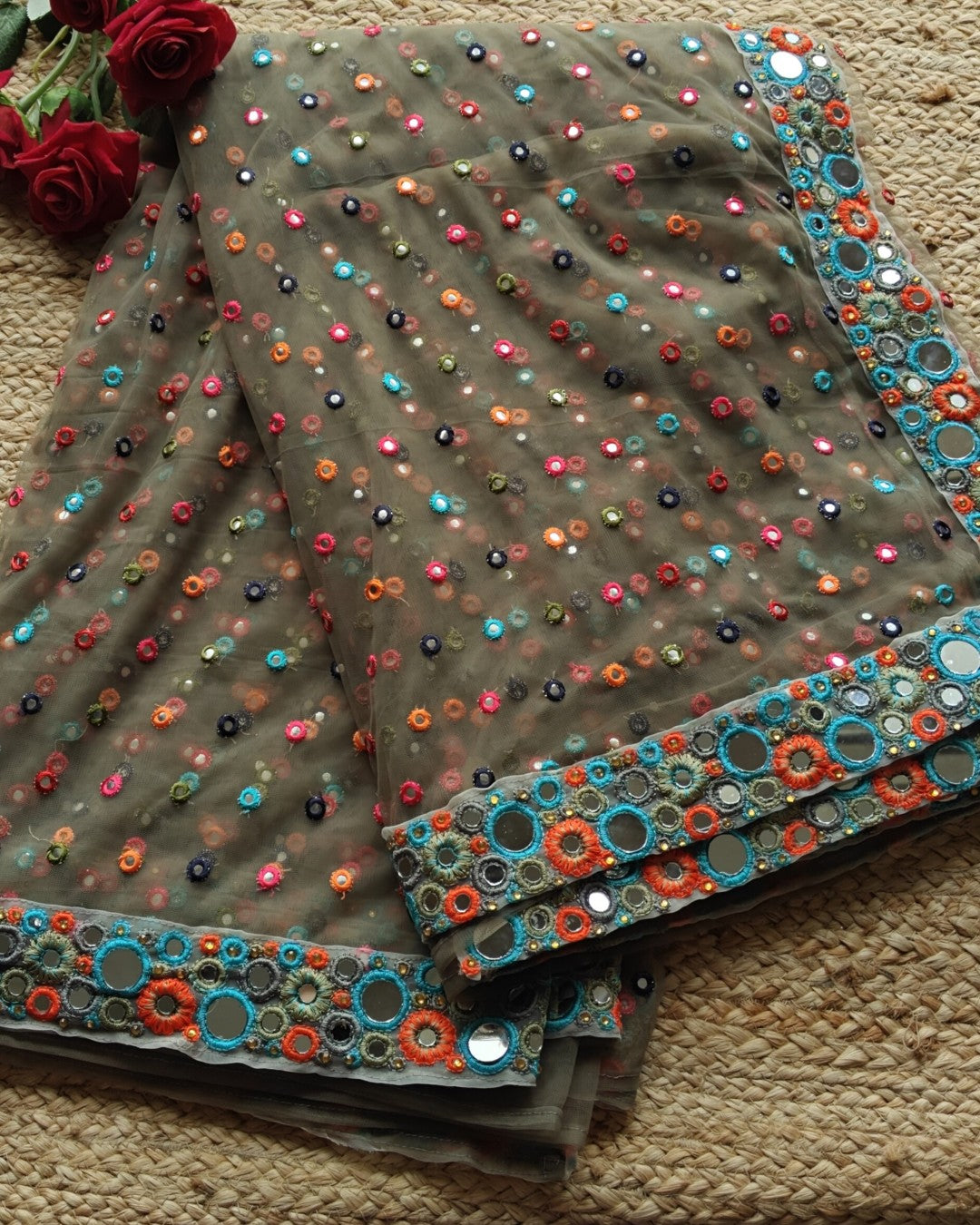 Dark Net saree with multi color thread embroidery and mirror border.