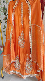 Orange Designer Partywear shimmer tissue unstitched suit.