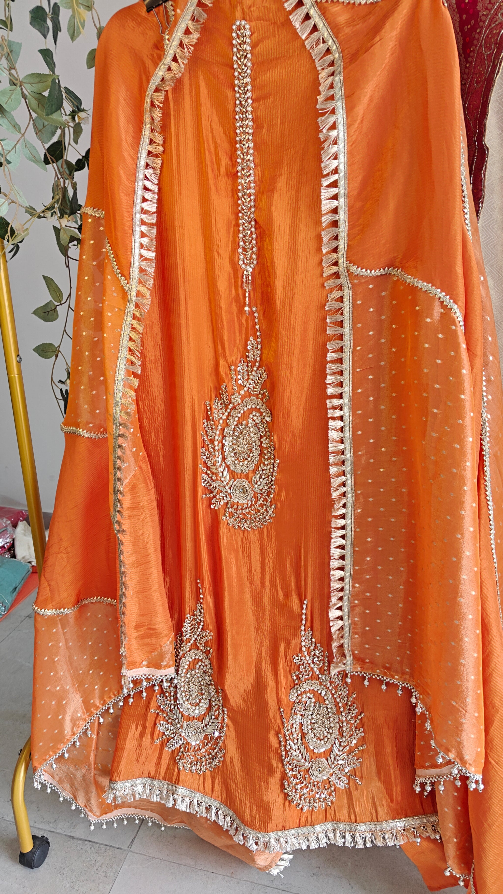 Orange Designer Partywear shimmer tissue unstitched suit.
