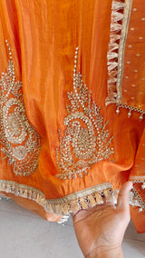 Orange Designer Partywear shimmer tissue unstitched suit.