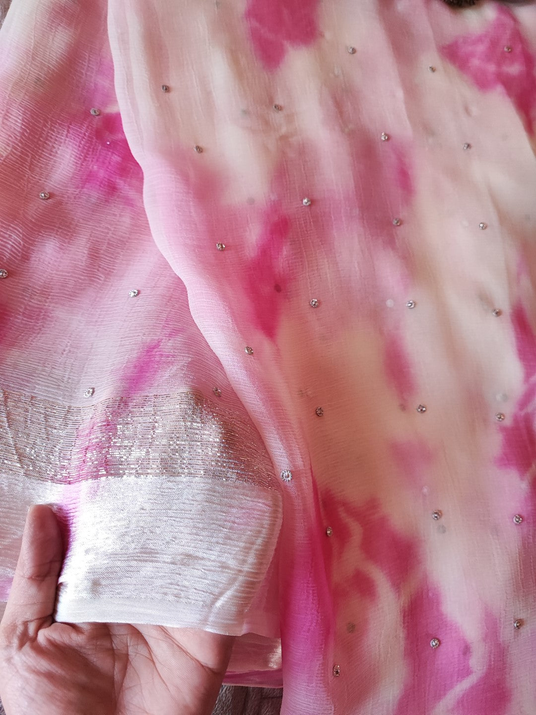 Pink Chiffon saree with silver Zari border.