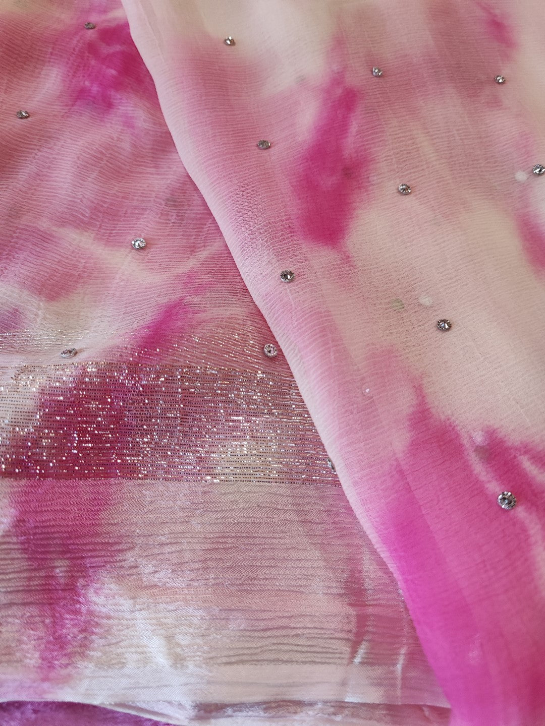 Pink Chiffon saree with silver Zari border.