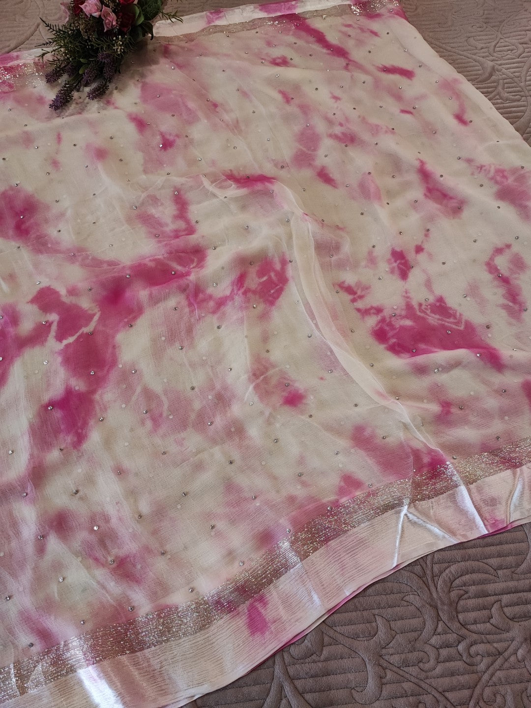 Pink Chiffon saree with silver Zari border.