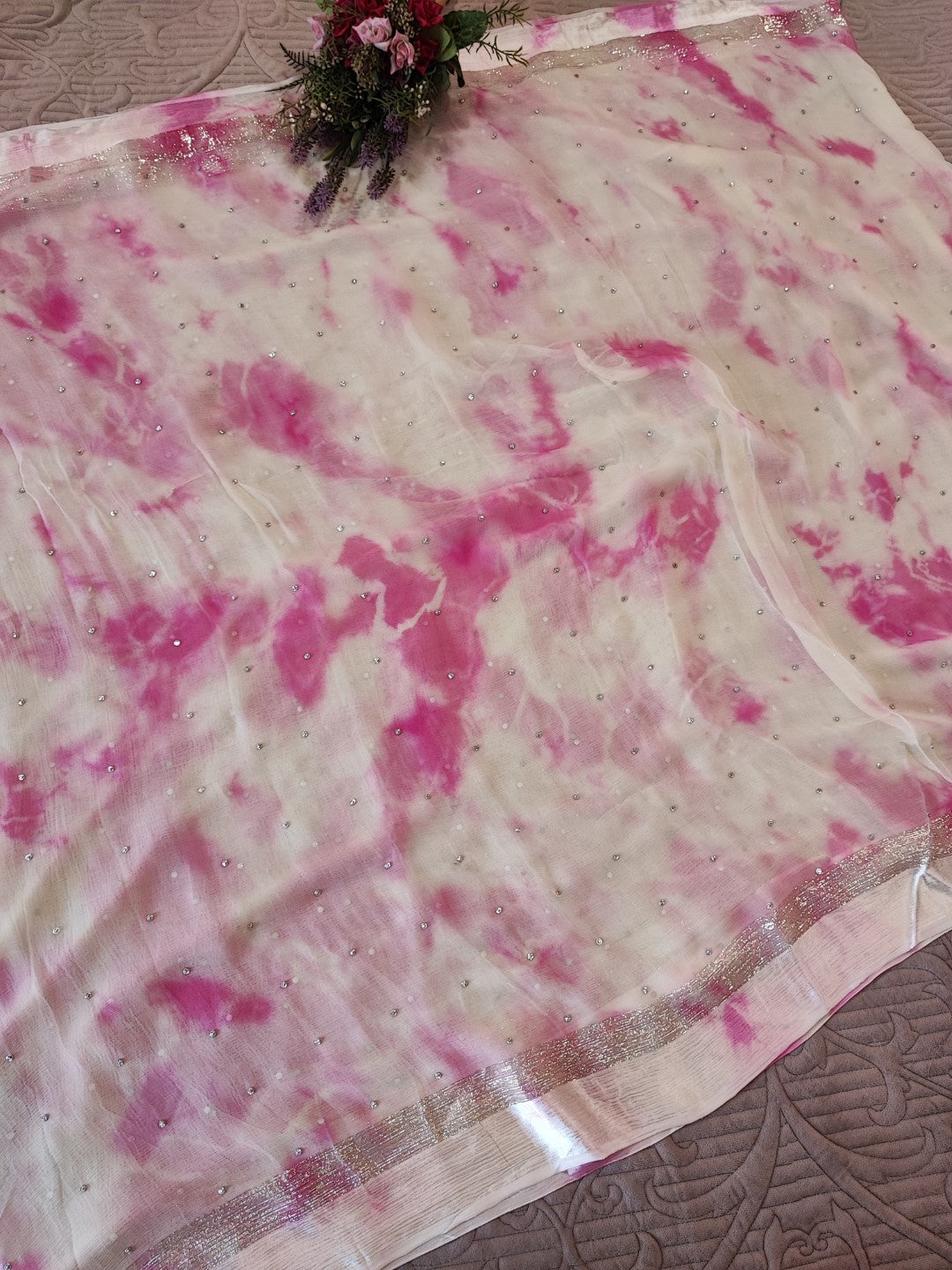 Pink Chiffon saree with silver Zari border.