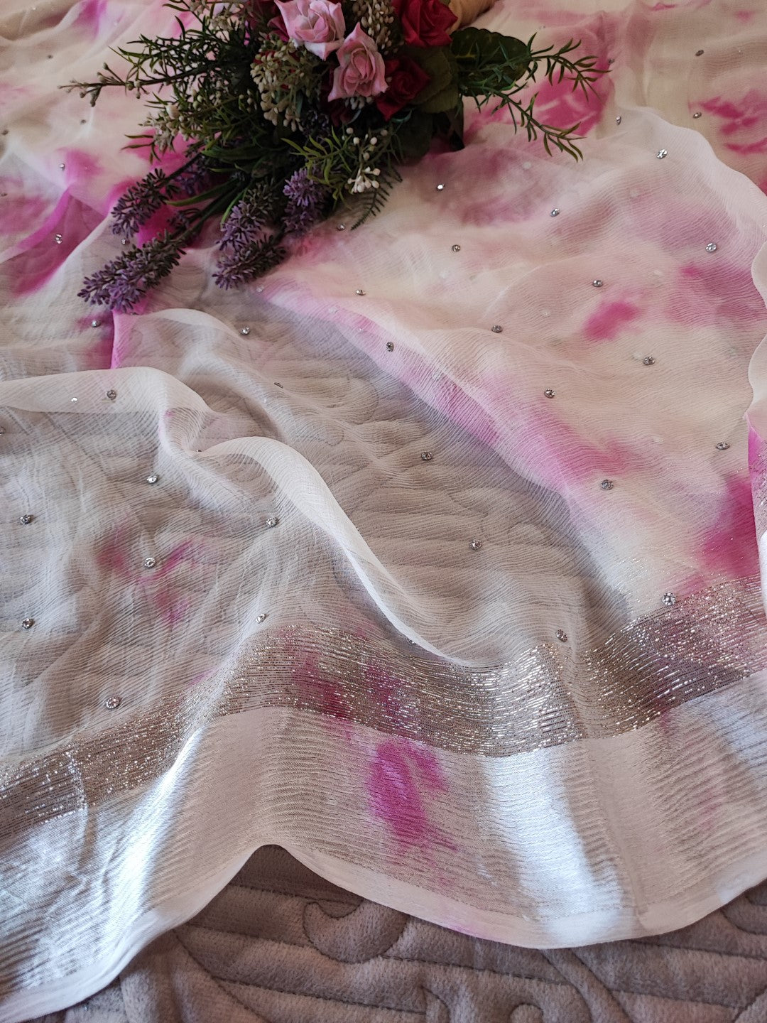 Pink Chiffon saree with silver Zari border.