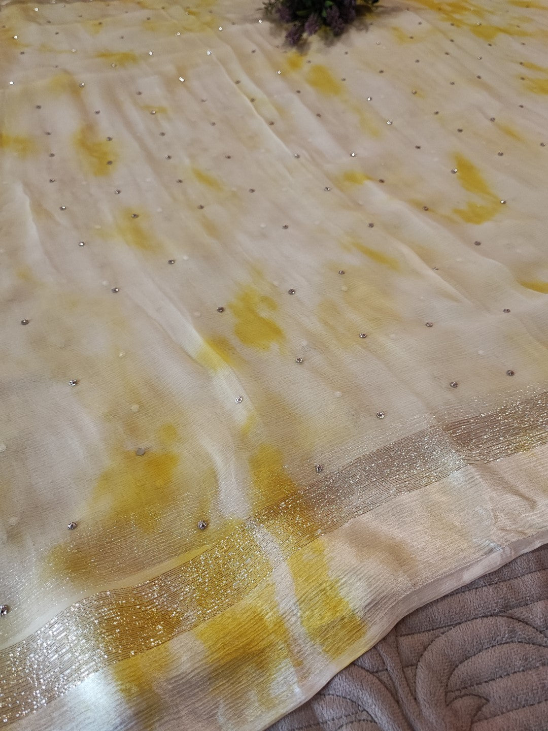 Yellow Chiffon saree with silver Zari border.