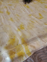 Yellow Chiffon saree with silver Zari border.