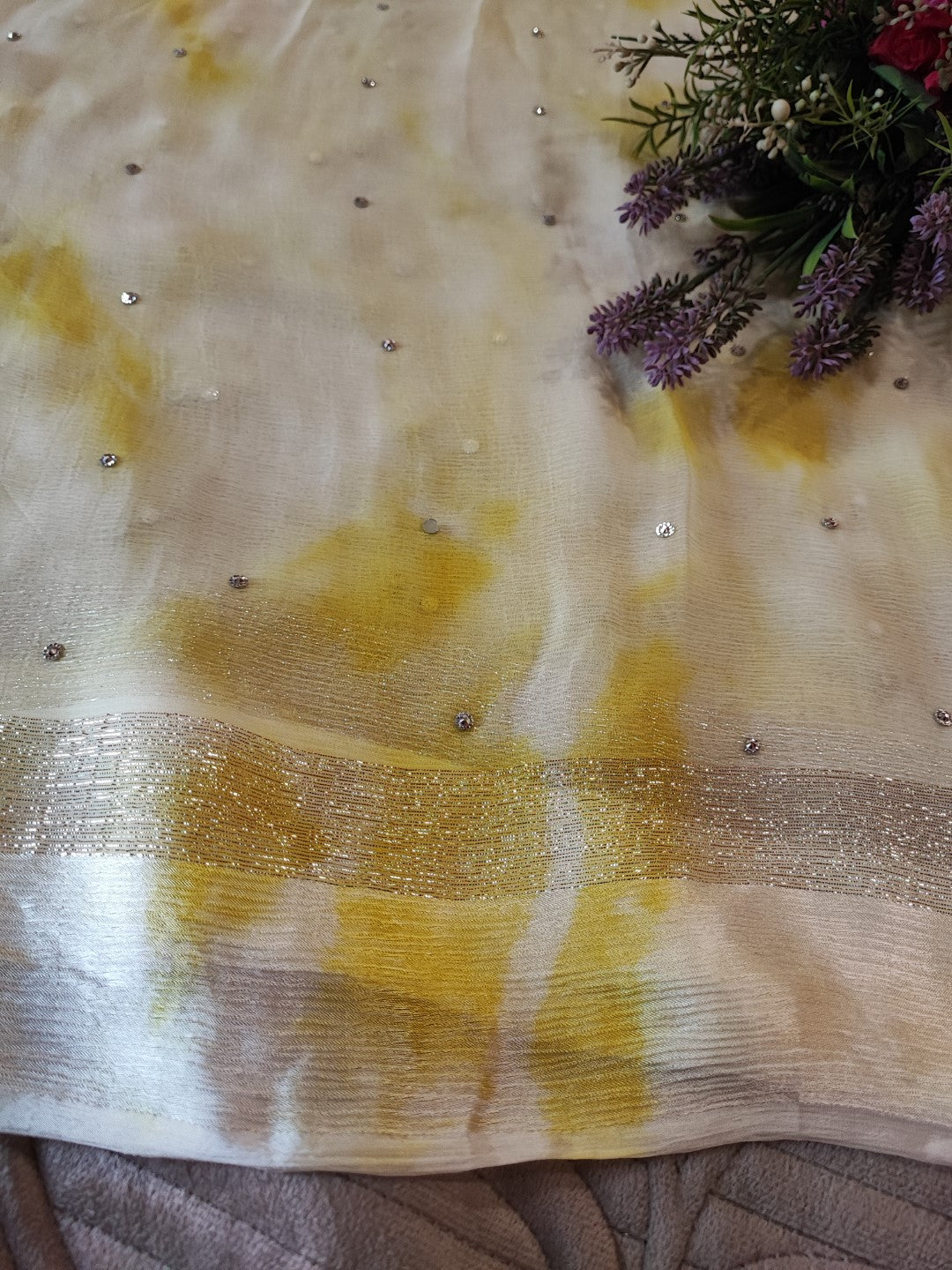 Yellow Chiffon saree with silver Zari border.