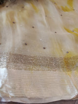 Yellow Chiffon saree with silver Zari border.