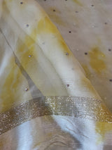 Yellow Chiffon saree with silver Zari border.