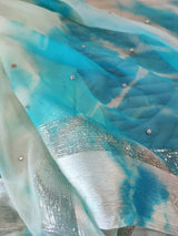 Blue Chiffon saree with silver Zari border.