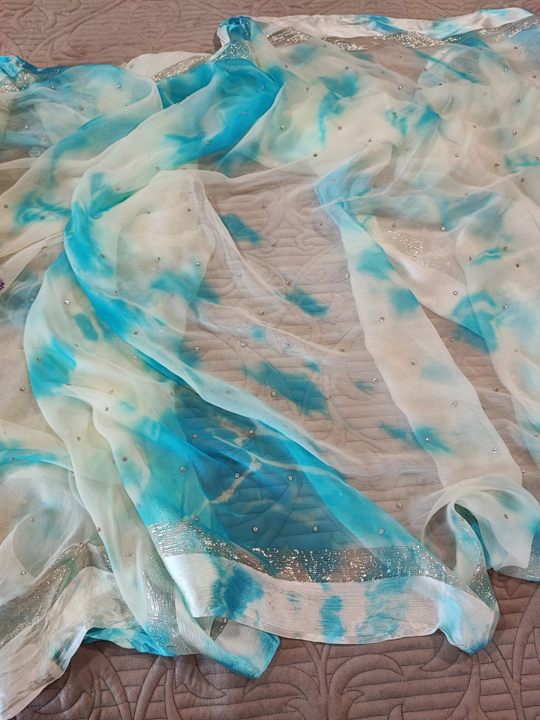 Blue Chiffon saree with silver Zari border.