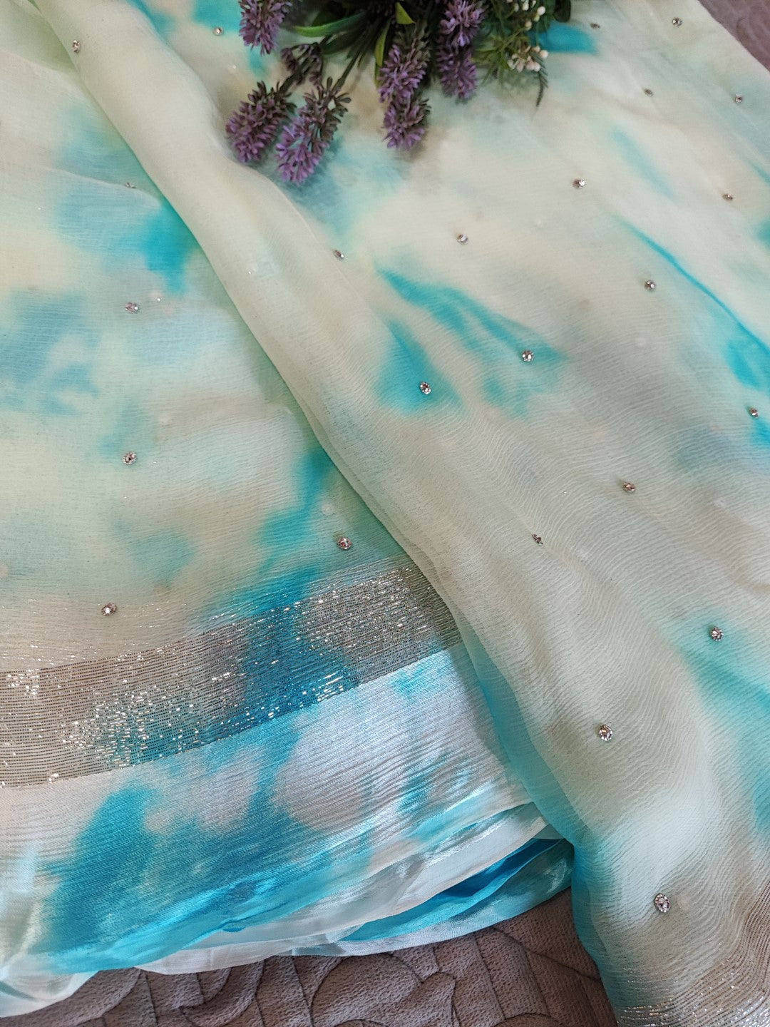 Blue Chiffon saree with silver Zari border.