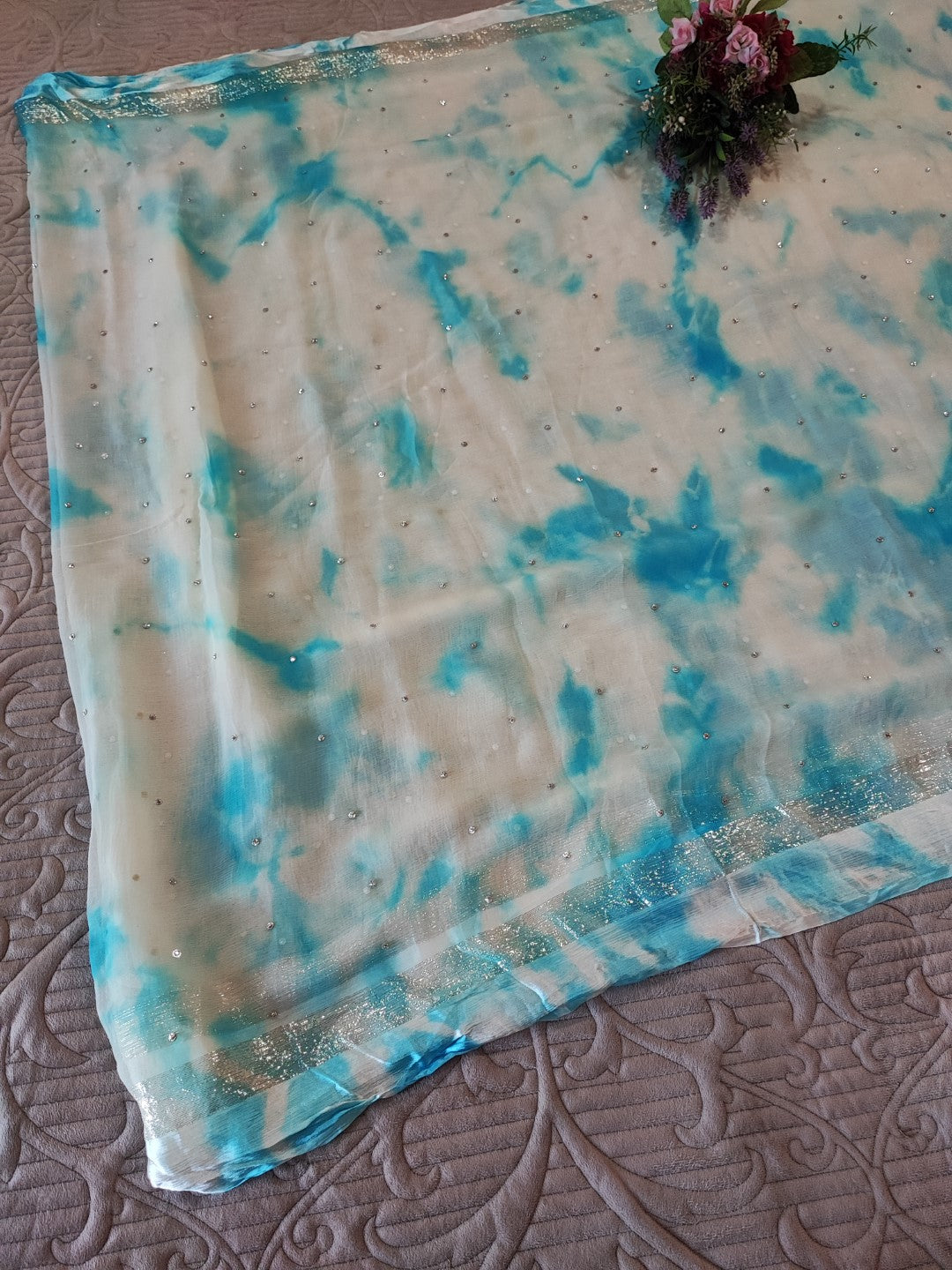 Blue Chiffon saree with silver Zari border.