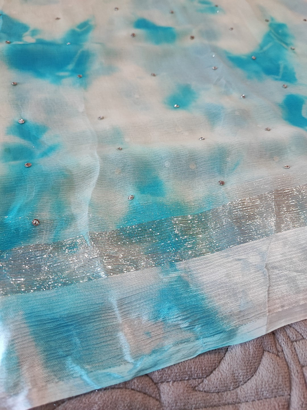 Blue Chiffon saree with silver Zari border.