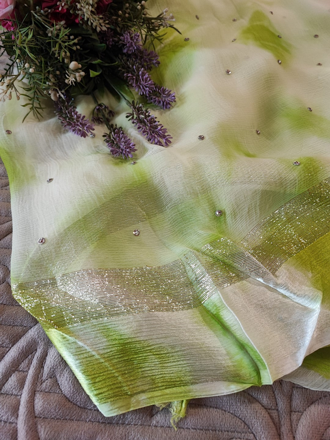 Green Chiffon saree with silver Zari border.