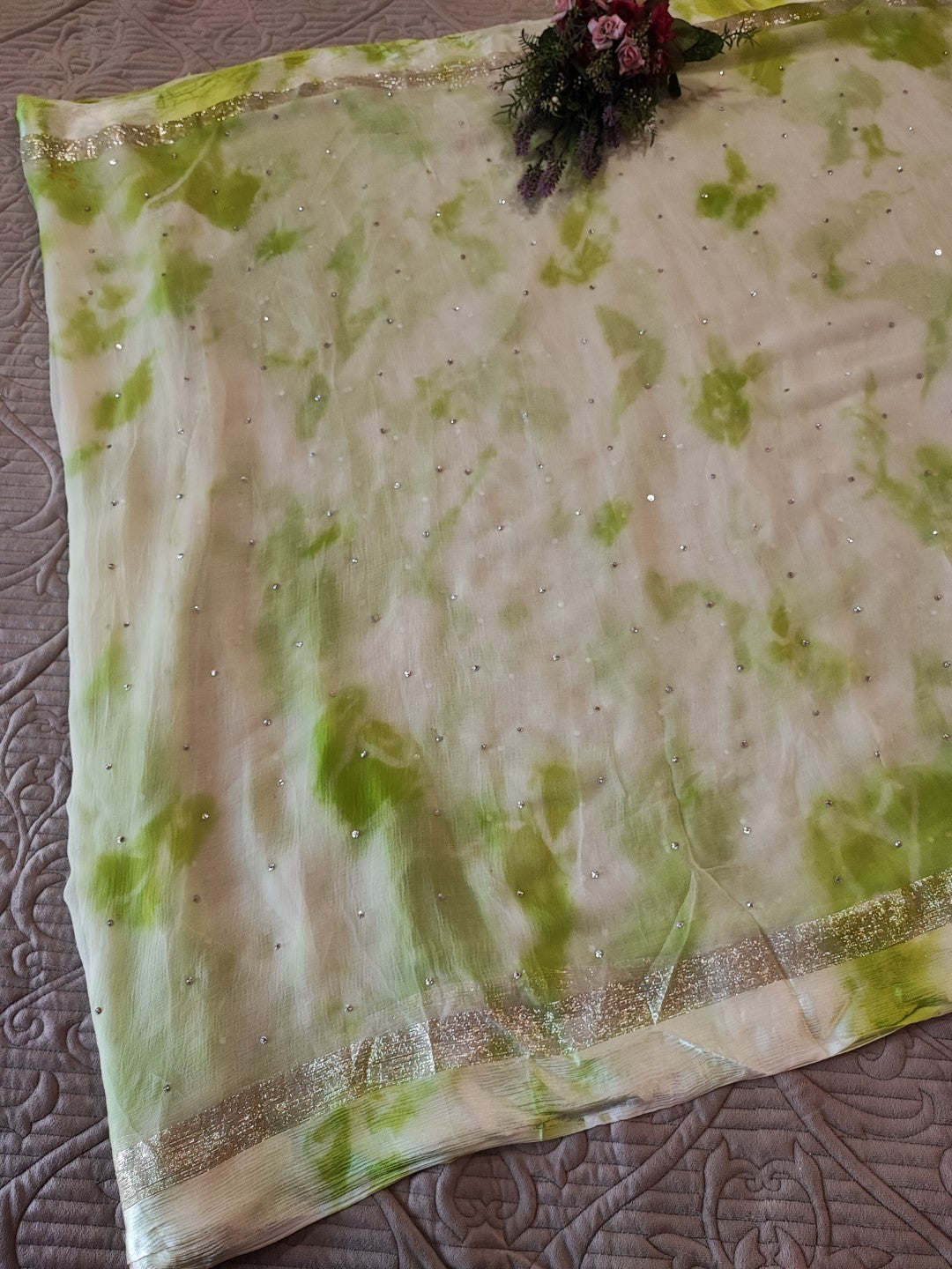 Green Chiffon saree with silver Zari border.