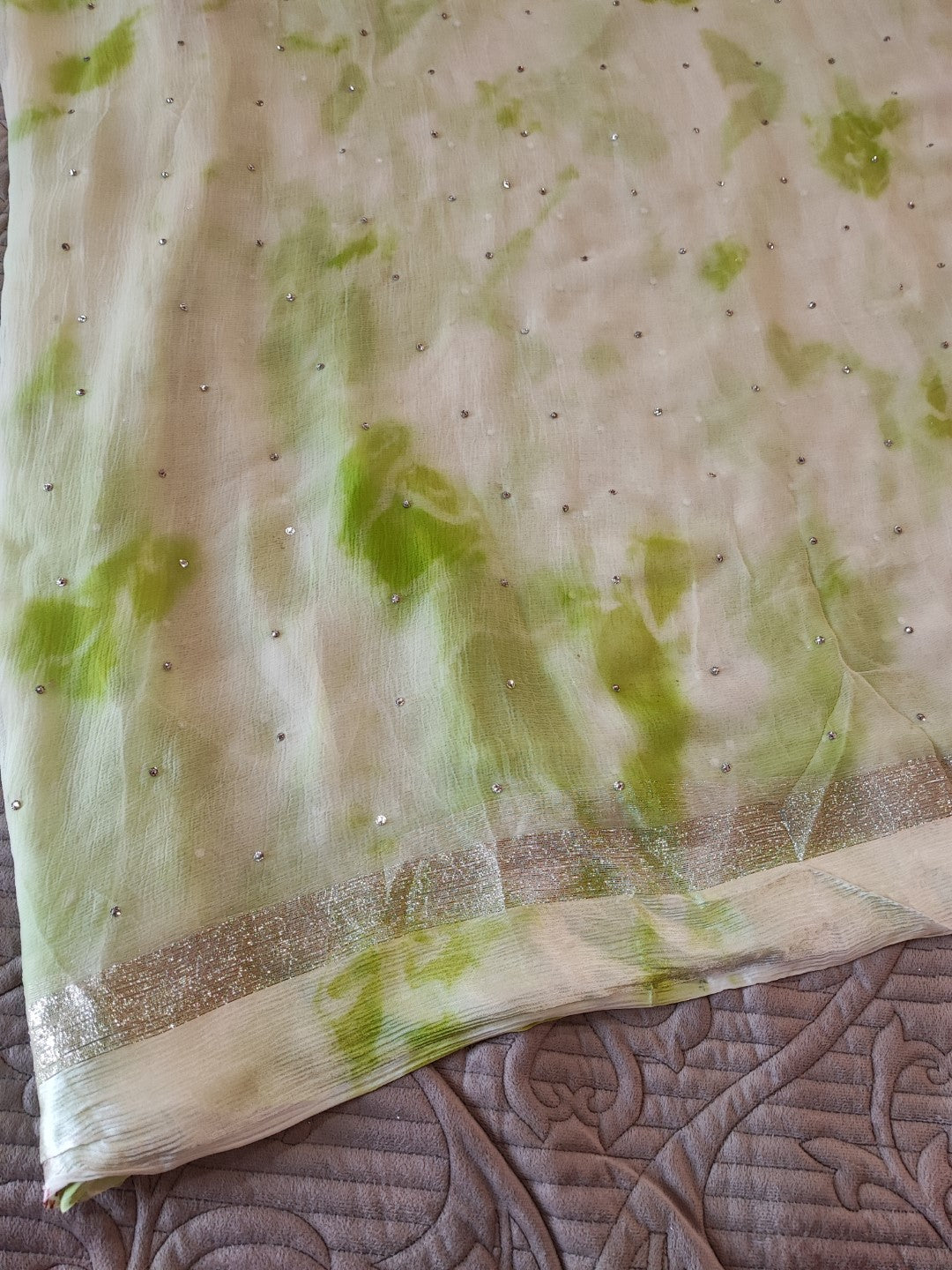 Green Chiffon saree with silver Zari border.