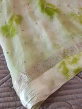 Green Chiffon saree with silver Zari border.