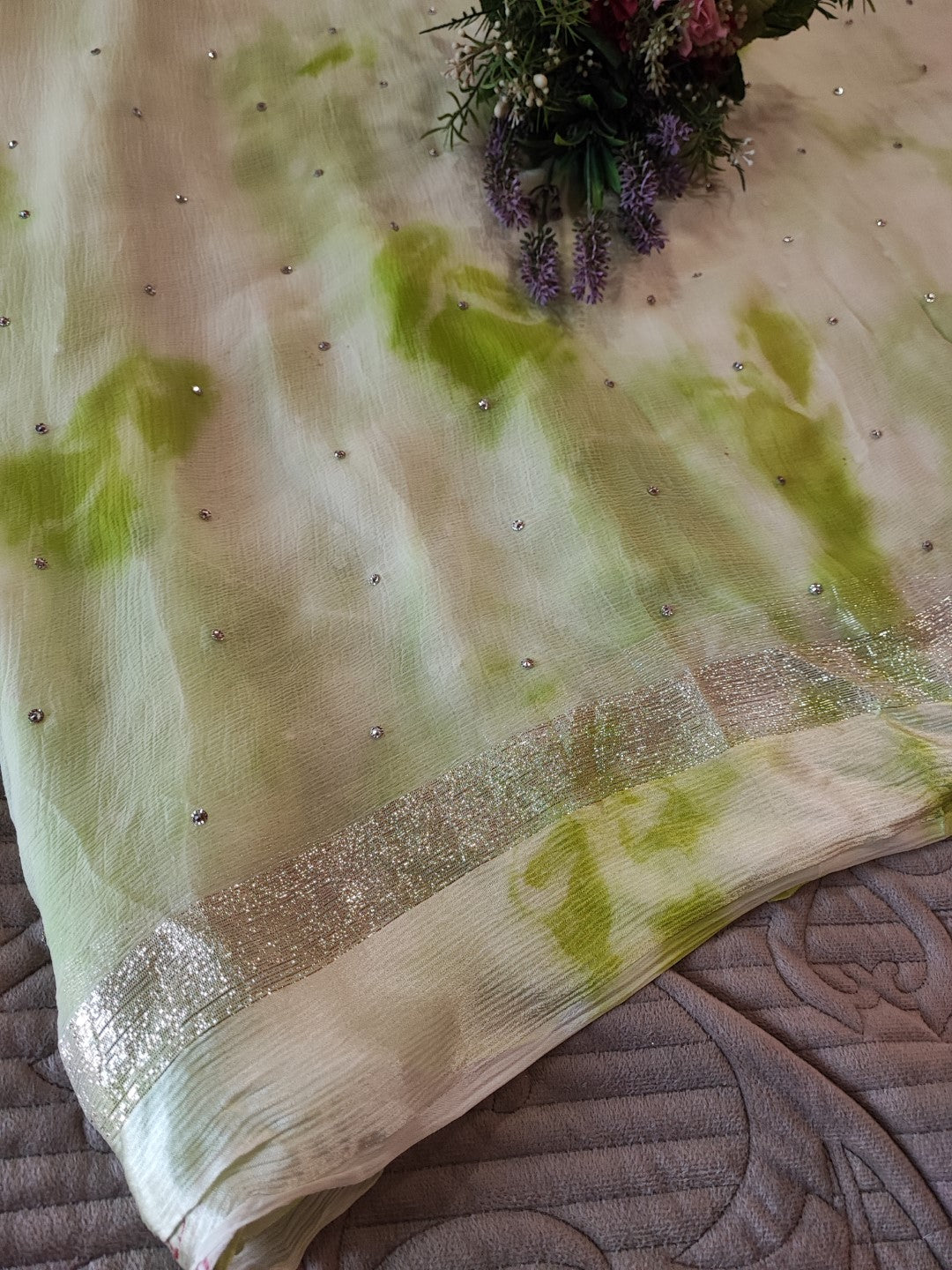 Green Chiffon saree with silver Zari border.