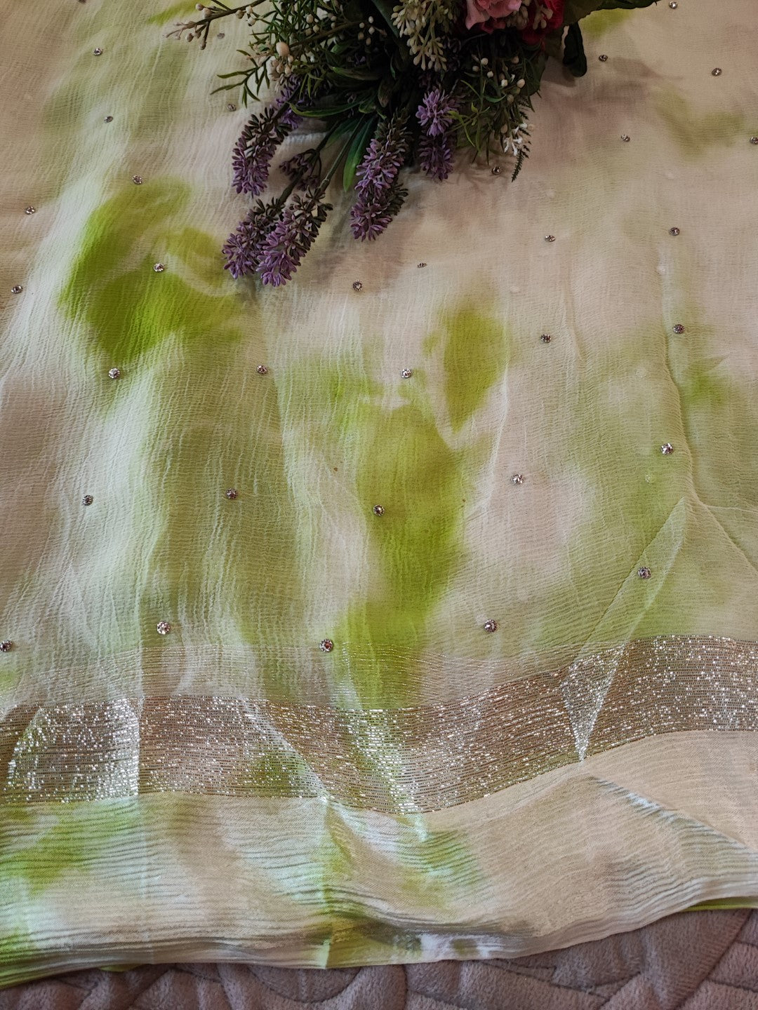 Green Chiffon saree with silver Zari border.