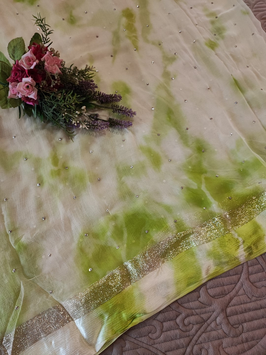 Green Chiffon saree with silver Zari border.