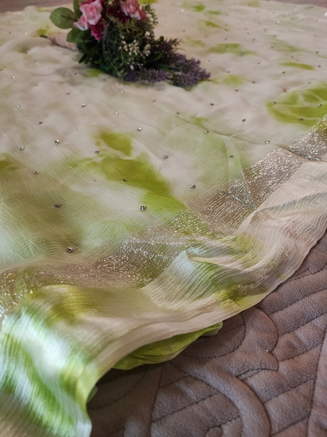 Green Chiffon saree with silver Zari border.