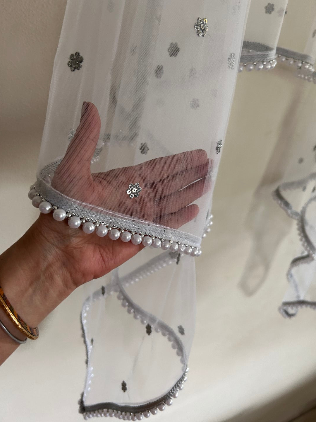 White Net dupatta with white moti border.
