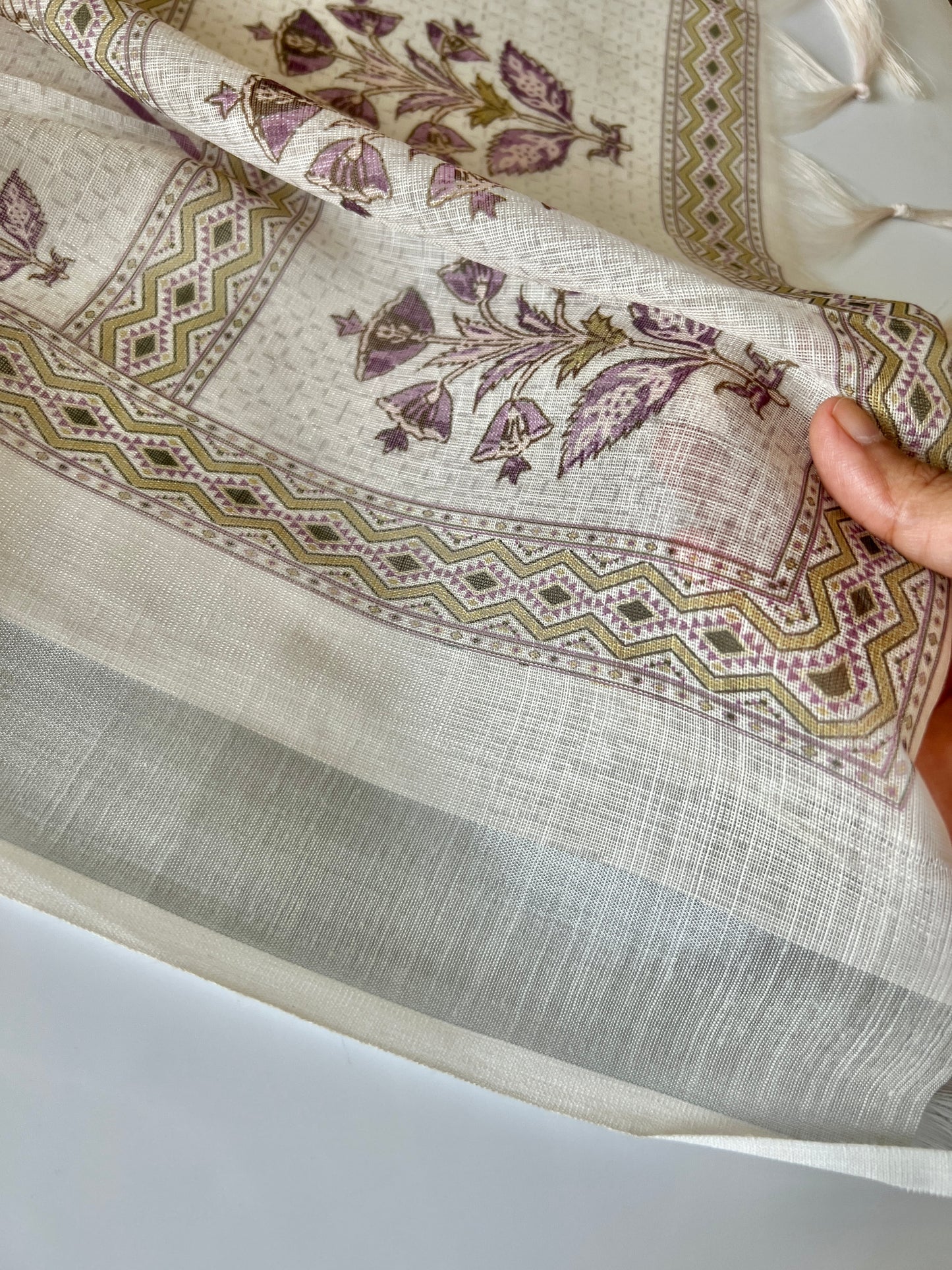 Elegant light cream dress material featuring traditional pitta work and soft breathable mul linen fabric