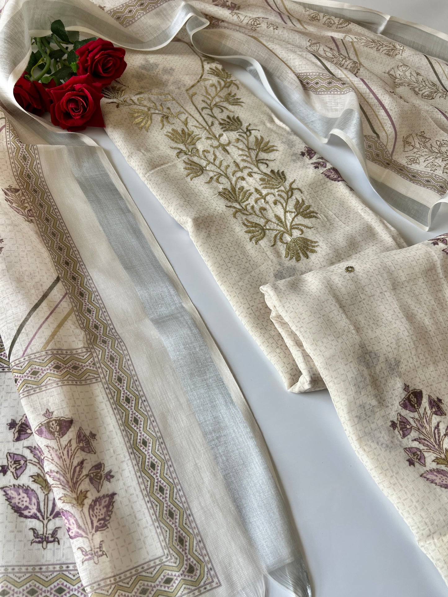 Elegant light cream dress material featuring traditional pitta work and soft breathable mul linen fabric