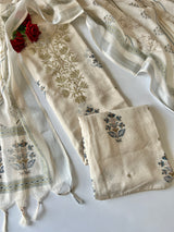 Elegant light cream dress material featuring traditional pitta work and soft breathable mul linen fabric