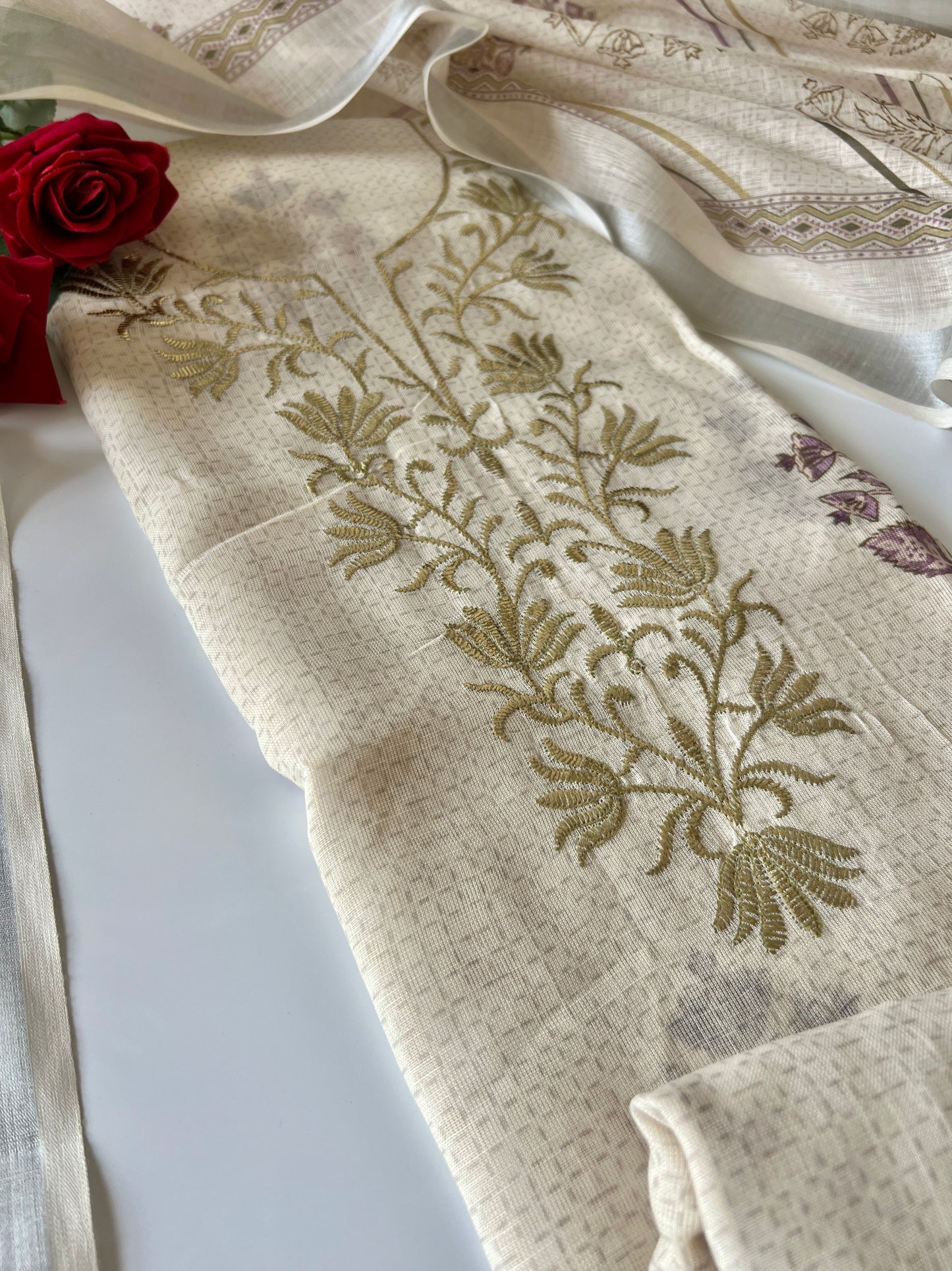 Premium cream mul linen dress material for women featuring subtle printed ethnic design and pitta detailing