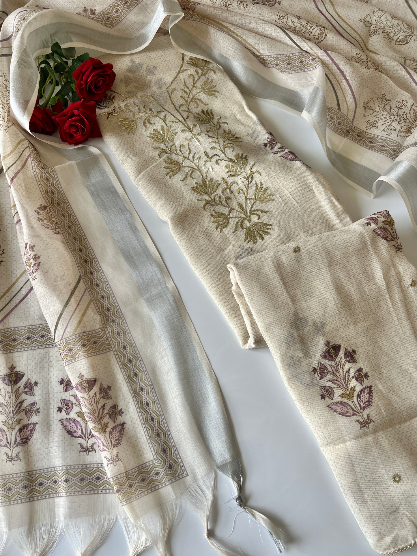 Elegant light cream dress material featuring traditional pitta work and soft breathable mul linen fabric