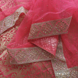 pink unstitched salwar suit with elegant brocade work and sparkling dotted dupatta