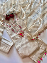 Premium cream tissue dress material with elegant neck embroidery and pom pom latkans for festive ethnic wear