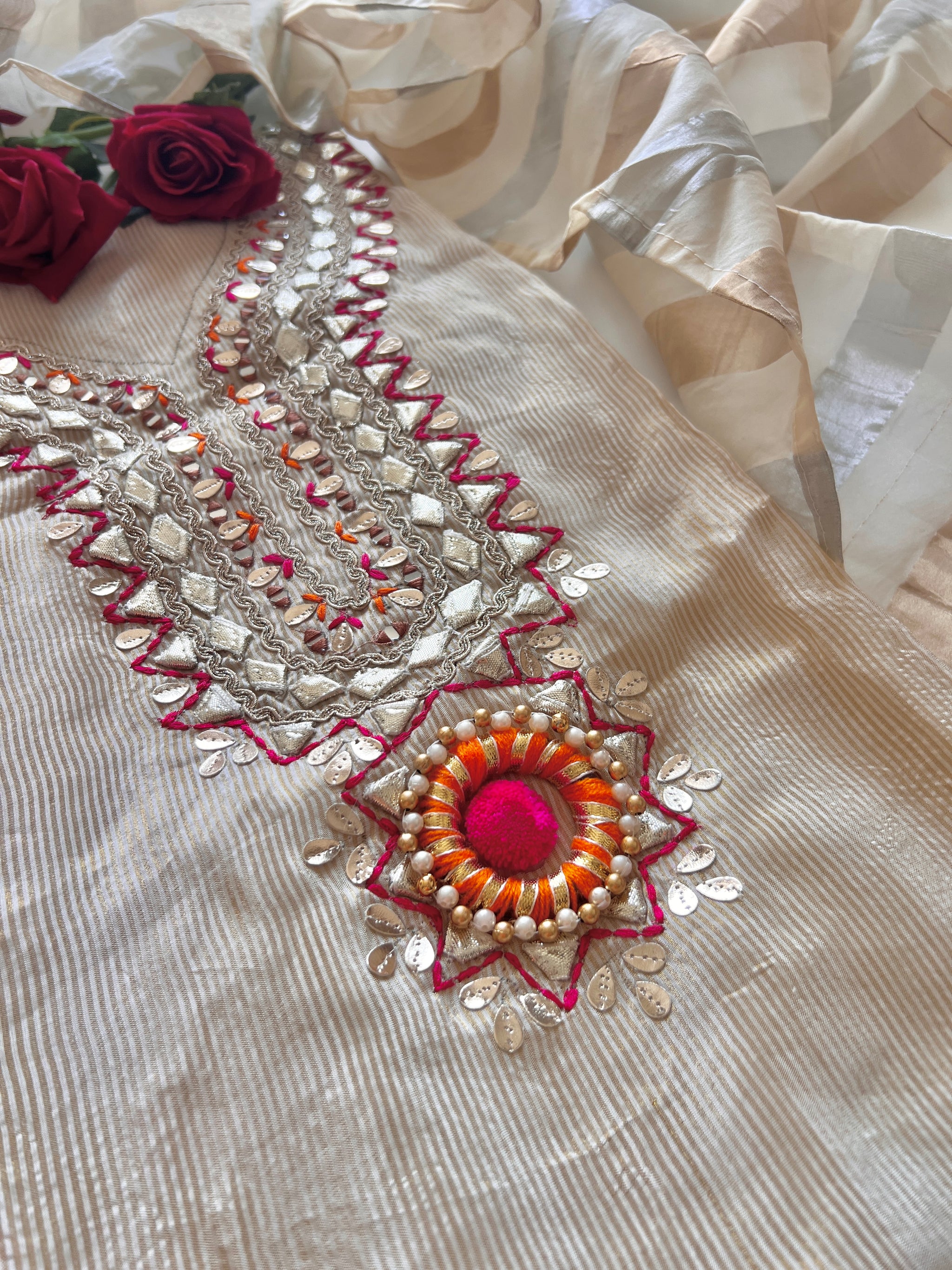 Premium cream ethnic dress material online with tissue fabric, subtle embroidery and festive pom pom accents