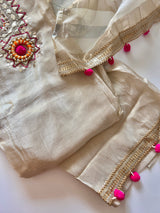 Cream unstitched salwar suit material in tissue fabric with embroidered neckline and designer pom pom detailing
