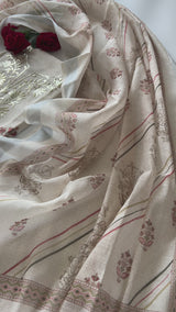 Elegant light cream mul linen unstitched salwar suit material featuring delicate pitta work and graceful all over prints. Perfect for daytime functions, festive gatherings and sophisticated ethnic styling.